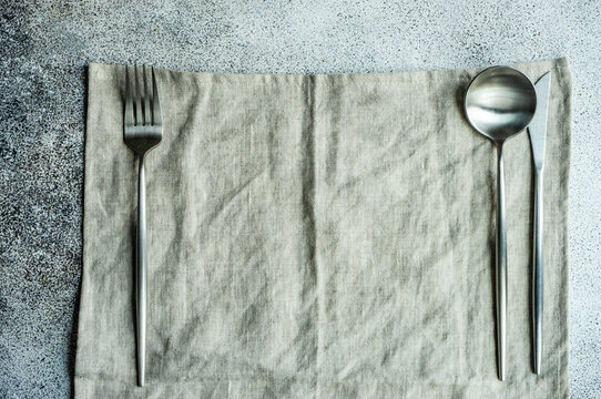 Overhead view of a minimalistic place setting on a table mat