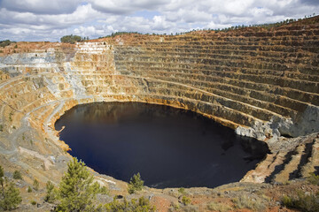Inactive quarry Corta Atalaya with a red lake at the bottom. Riotinto, Spain.	