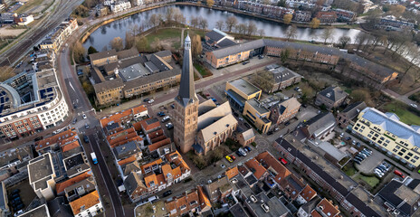 Fototapeta premium Panorama aerial of historic city center and defense moat surrounding Hanseatic Zutphen with St. Janskerk church tower rising above