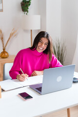 Smiling woman writing in notepad