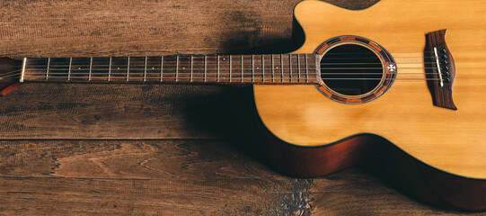 Top view of classical guitar on old wooden background.dark tone