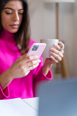 woman using smartphone at home