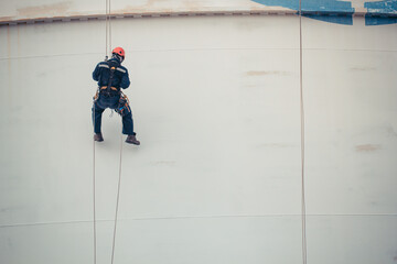 Male worker rope access  inspection of thickness  storage tank