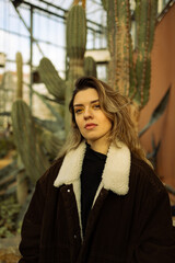 Young beautiful woman in front of cactus.