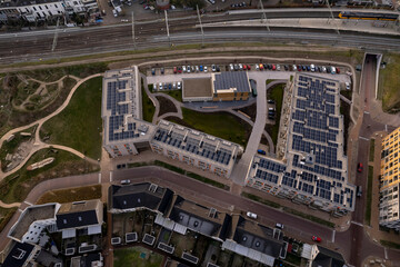 Residential community Ubuntuplein complex seen from above with roof full of solar panels in urban development of real estate investment project. Aerial top down housing and engineering concept