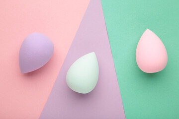 Beauty blender on colorful background. Bright sponges for make-up cosmetics.