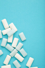 Pads of chewing gum on blue background. Fresh mint bubble gum. Vertical photo
