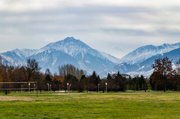 Fototapeta premium Park in autumn and mountains in the background. Almaty