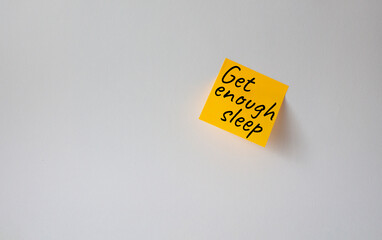 Get enough sleep symbol. Concept words Get enough sleep on orange steaky note. Beautiful white background. Healthy lifestyle, medical and Get enough sleep concept. Copy space.