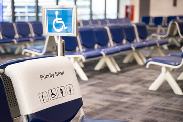 Fototapeta premium Close-up of a chair in an airport seat, a passenger's special seat. Empty metal chair in the airport waiting room furniture pictures Airport departure or arrival concept image