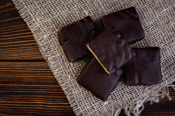Chocolate candies souffle Tiramisu on dark wooden background.