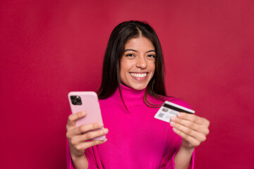 Fototapeta premium Excited woman with smartphone and credit card