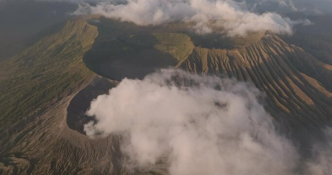 Aerial Panning Beautiful View Of Smoke From Volcanic Mountains In Sunlight - Java, Indonesia