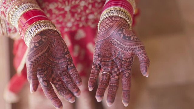 Mehndi design for hands. Close-up of adult woman hands with wrinkles covered mehndi pattern