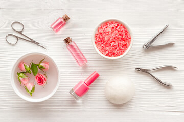 Fototapeta na wymiar Manicure scissor and hands care cosmetics set with flowers.