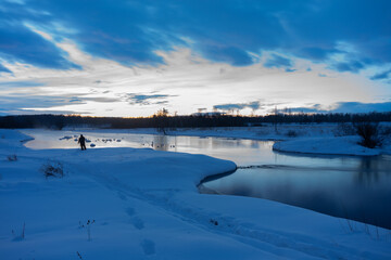Morning, winter landscape of an unfrozen river on a long exposure