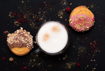 cappuccino with many layers of coffee, milk and foam and croissants on black background. Image from...