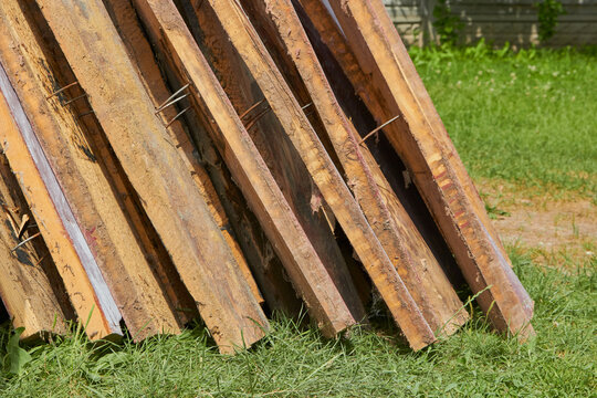 a pile of old boards with nails,wooden floor boards dismantled in the yard © retbool