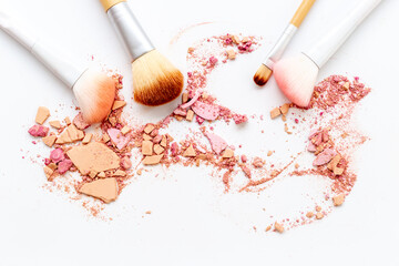 Nude colored makeup powder with brushes isolated on white background