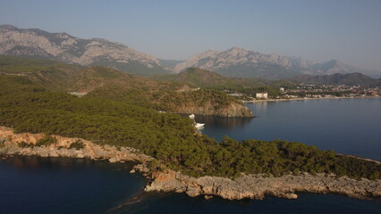 A bay Cennet Koyu with a Tahtalı Dagi mountain and Kemer view from a drone. 