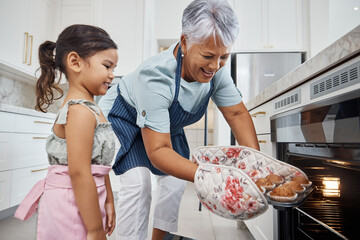 Muffins, learning and grandmother with girl cooking and taking out cupcakes from oven. Education, kitchen and happy grandma teaching child how to bake, bonding and enjoying quality time together.