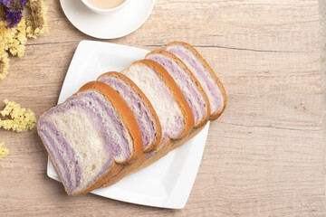 Sliced bread with taro and coffee on wooden background