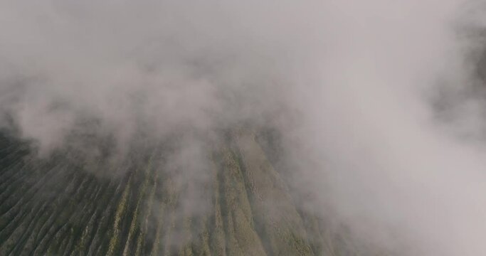 Aerial Forward Shot Of Smoke Spreading Over Volcanic Landscape - Java, Indonesia