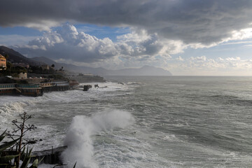 Rough sea and sky with clouds on the beach of Genoa Quinto, Italy