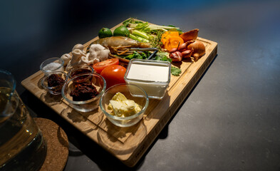 Ingredients of TomYamKung (Shrimp Spicy Thai Soup) is a lemon, prawn, chilli, lemon grass, onion, tomato, mushroom and condiment sauce on the kitchen counter.