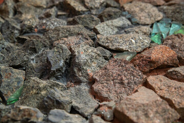 Stone patterns on the wall. Multi-colored marble stones. Structure of an old destroyed wall for a...
