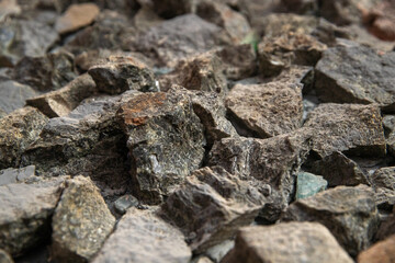 Stone patterns on the wall. Multi-colored marble stones. Structure of an old destroyed wall for a vintage closeup.