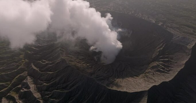 Aerial Panning Shot Of Smoke Emitting From Volcanic Mountain - Java, Indonesia