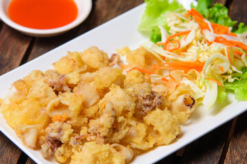 Fried crispy squid in the white dish.