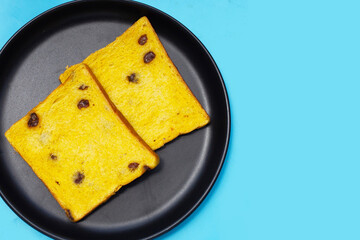 Whole grain bread slices on blue background.