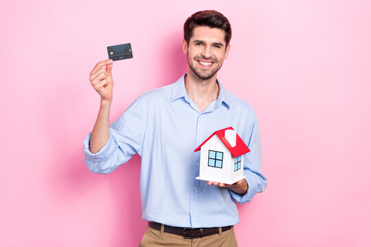 Photo of successful man realtor advise easy payment paypass buy new flat enjoy purchase isolated on pink color background