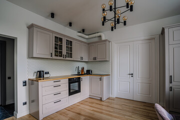 Fototapeta premium White and brown modern kitchen with wooden island