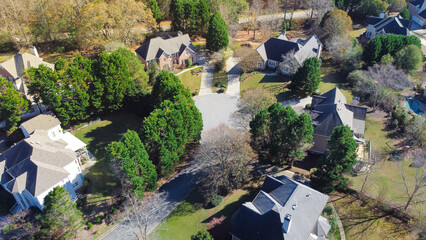 Two story houses in leafy suburb upscale neighborhood with cul-de-sac and lush green trees near...