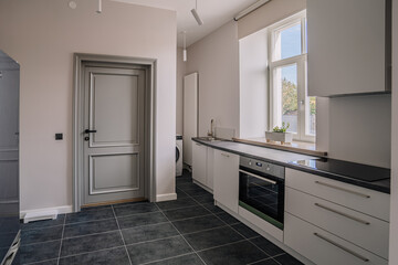 White and brown modern kitchen with wooden island