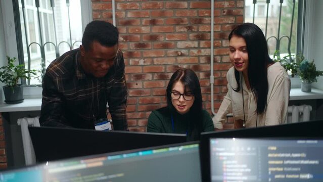 active discussion of team of web developers of designers in office, multiethnic man and women