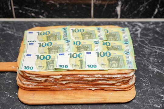 Pie with cream from euro banknotes. The concept of making fast money.