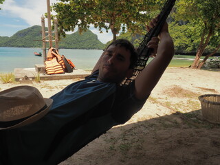 young man laying in a thailand beach
