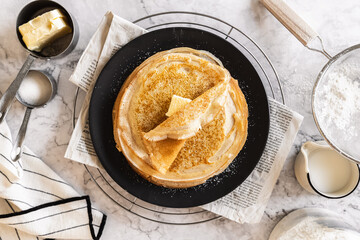 pancakes with butter on a white background with ingredients flour sugar butter