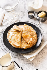 pancakes with butter on a white background with ingredients flour sugar butter