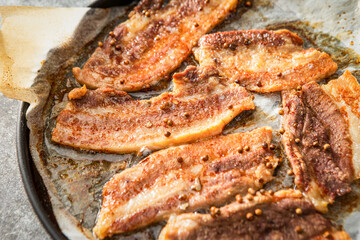 Whole pork belly grilled in an oven pan