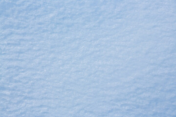 Fototapeta premium Natural snow texture. Smooth surface of clean fresh snow. Snowy ground. Winter background with snow patterns. Perfect for Christmas and New Year design. Closeup top view.