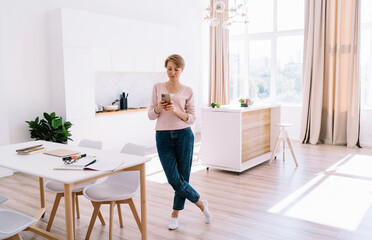 Woman using smartphone at home office