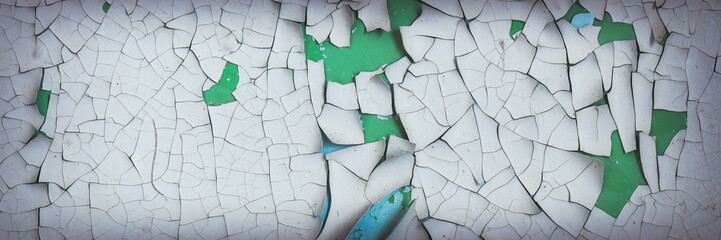 Peeling paint on the wall. Panorama of a concrete wall with old cracked flaking paint. Weathered...