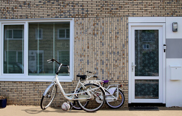 Fototapeta na wymiar Front of Dutch family house with bicycles and football, Netherlands