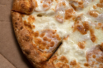 Pizza with ham in an open cardboard box. High quality photo