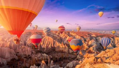 Fotobehang Koraal Amazing Panoramic view sunrise rocky landscape in Cappadocia with colorful hot air balloon deep canyons, valleys. Concept banner travel Turkey  © Parilov